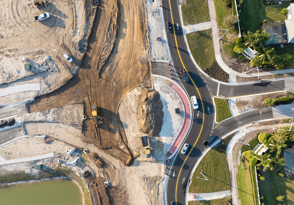 Roadworks construction site at roundabout intersection on American highway. Development of city circular transportation crossroads.